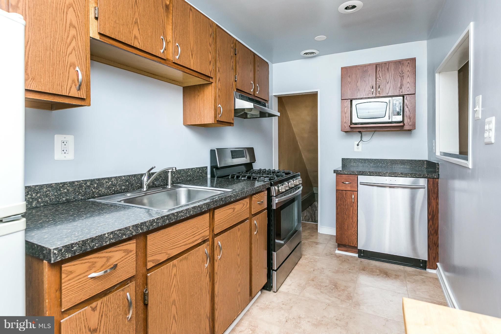 3609 Yolando Road Baltimore, MD 21218 - Photo 15 of 27 a kitchen with stainless steel appliances granite countertop a sink stove and cabinets