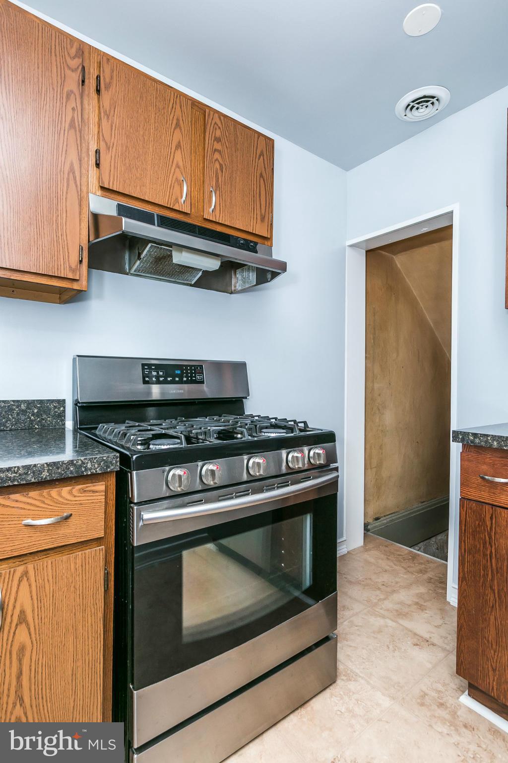3609 Yolando Road Baltimore, MD 21218 - Photo 16 of 27 a kitchen with stainless steel appliances granite countertop a stove and a microwave