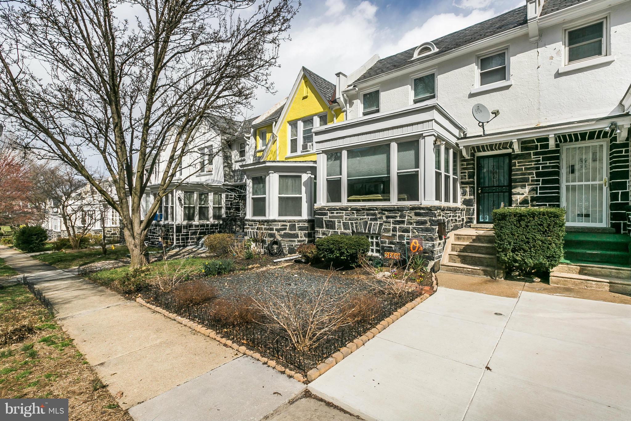 3609 Yolando Road Baltimore, MD 21218 - Photo 3 of 27 a front view of a house with a yard and potted plants