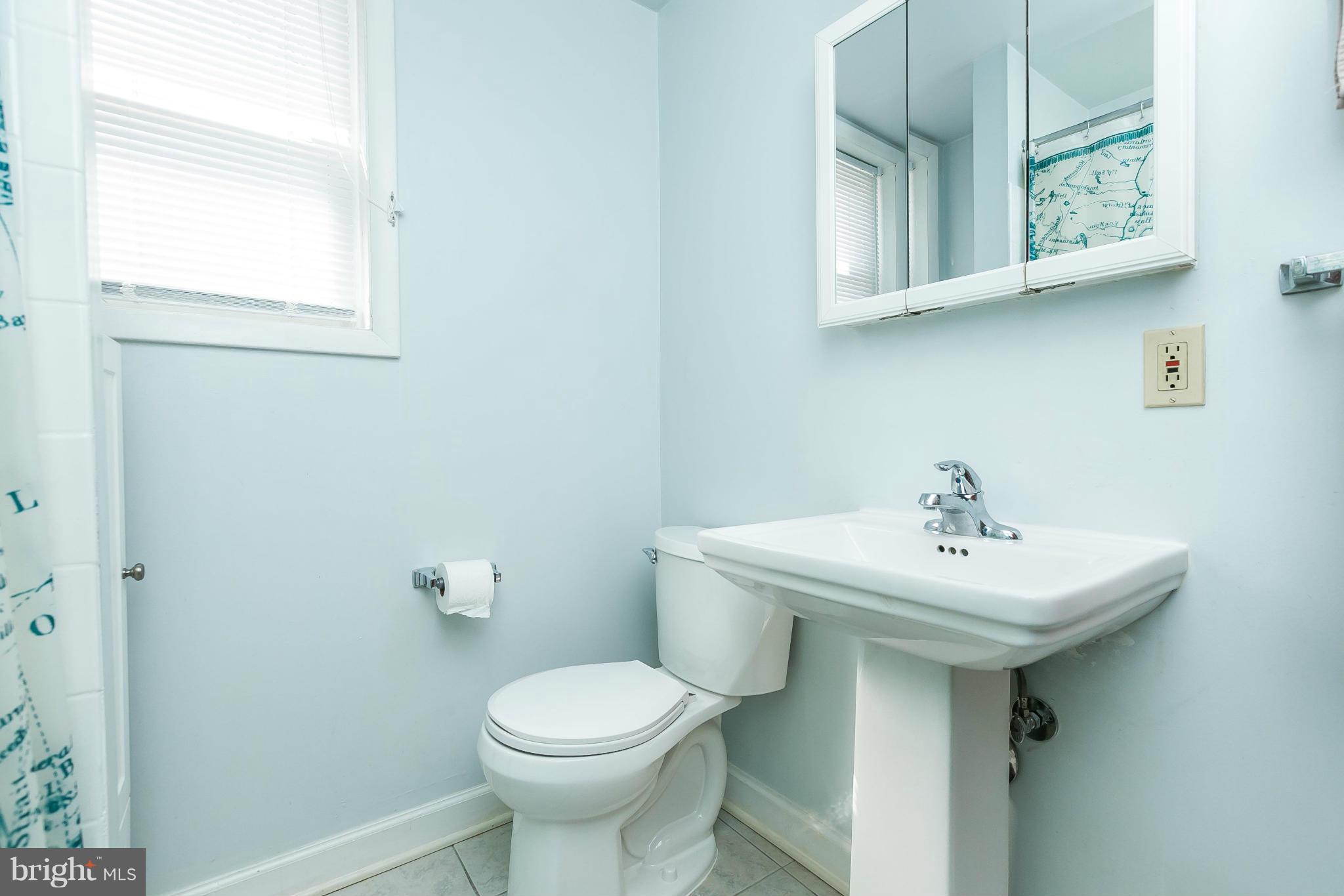 3609 Yolando Road Baltimore, MD 21218 - Photo 23 of 27 a bathroom with a sink mirror and toilet