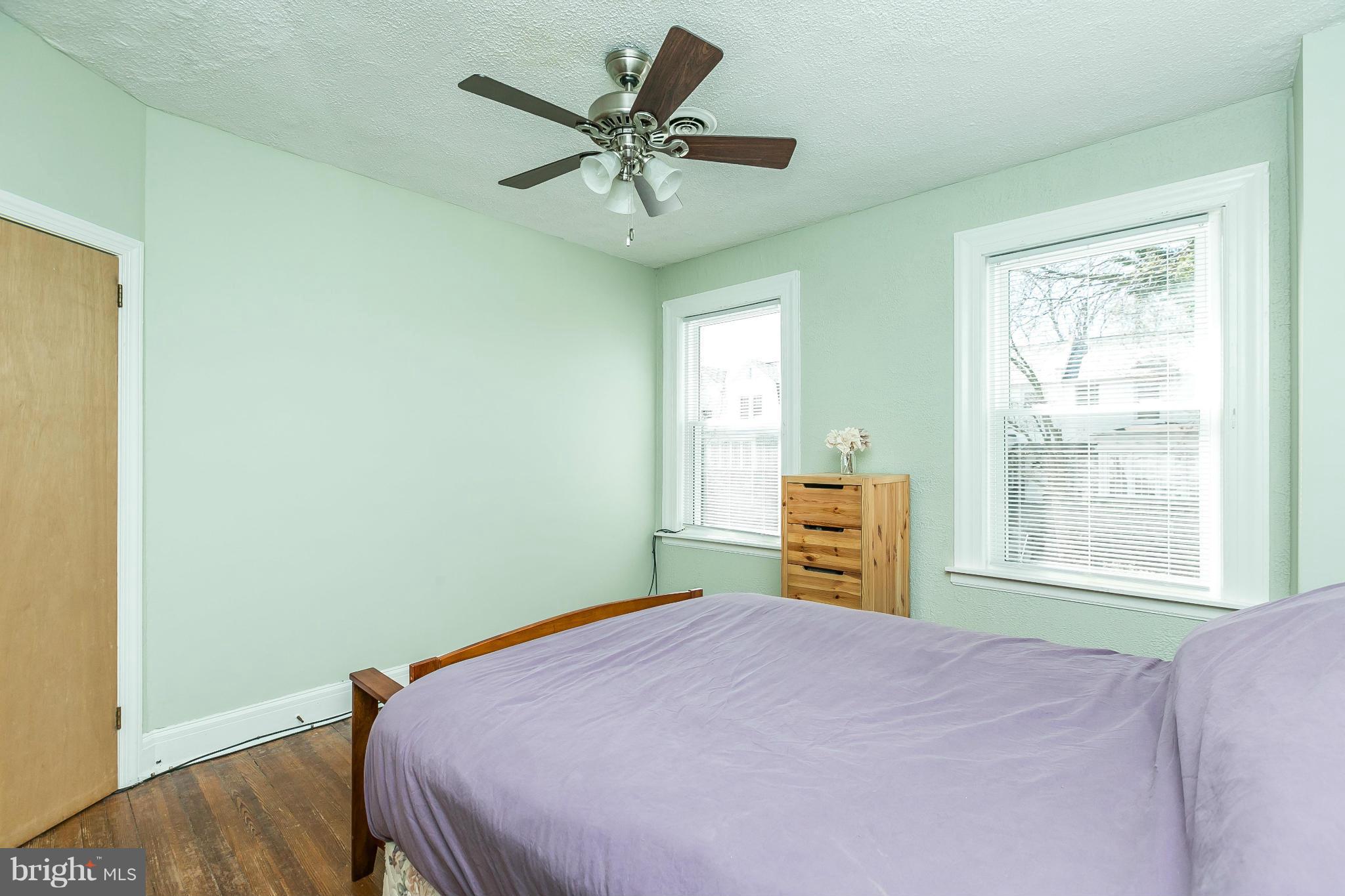 3609 Yolando Road Baltimore, MD 21218 - Photo 25 of 27 a bedroom with a bed and wooden floor