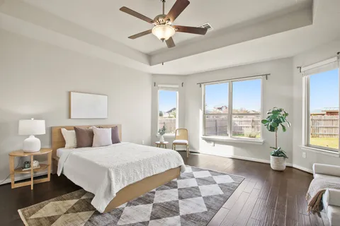 a bedroom with a large bed and a couch