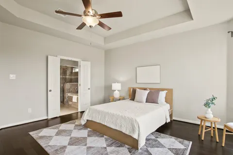 a bedroom with a bed and a potted plant