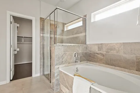 a bathroom with a tub and shower