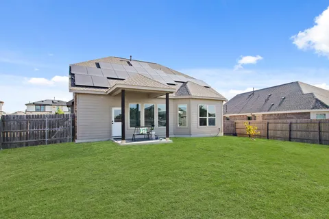 a view of a house with a yard and sitting area
