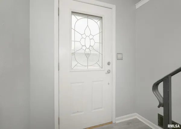 a view of a room with wooden floor and a ceiling fan