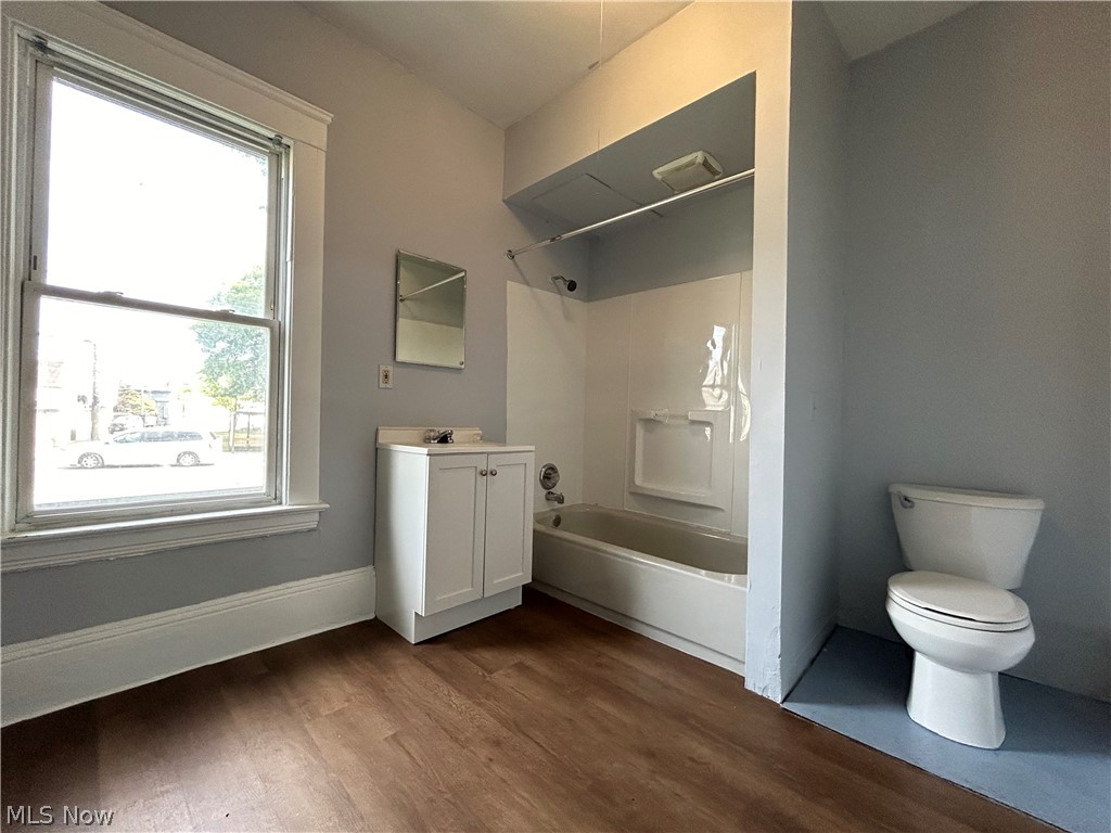 3403 Fulton Road, Unit DOWN Cleveland, OH 44109 - Photo 12 of 18 Full bathroom featuring vanity, toilet, hardwood / wood-style flooring, and shower / washtub combination