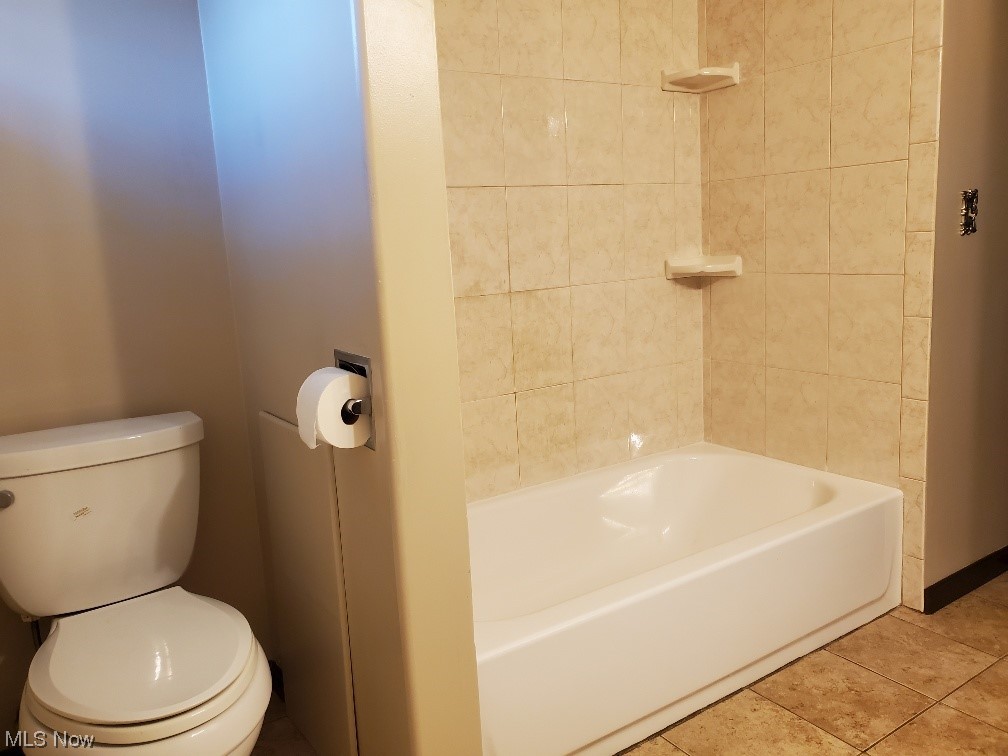12221 Reno Drive Parma, OH 44130 - Photo 26 of 29 Bathroom featuring tiled shower / bath combo, tile flooring, and toilet