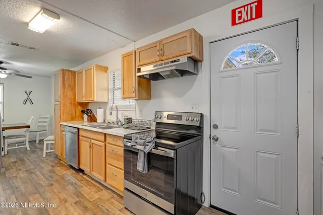 a kitchen with stainless steel appliances a stove a sink and a refrigerator