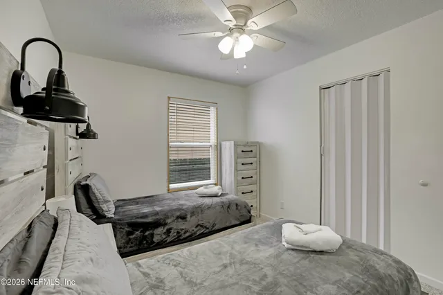 a bedroom with bed and a window