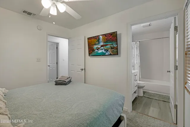 a bedroom with a bed and a painting on the wall