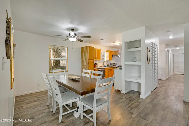 a view of a dining room with furniture and a chandelier