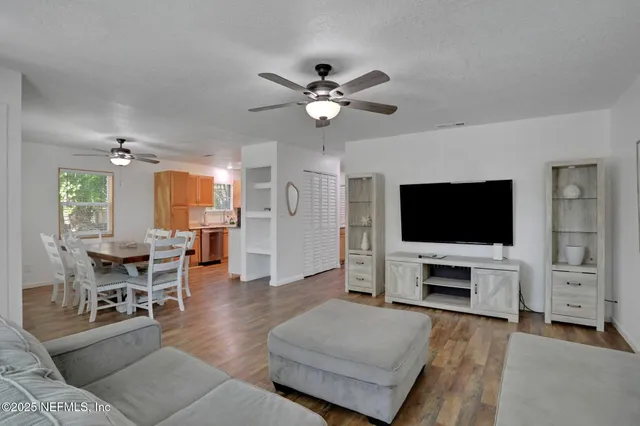 a living room with furniture and a ceiling fan