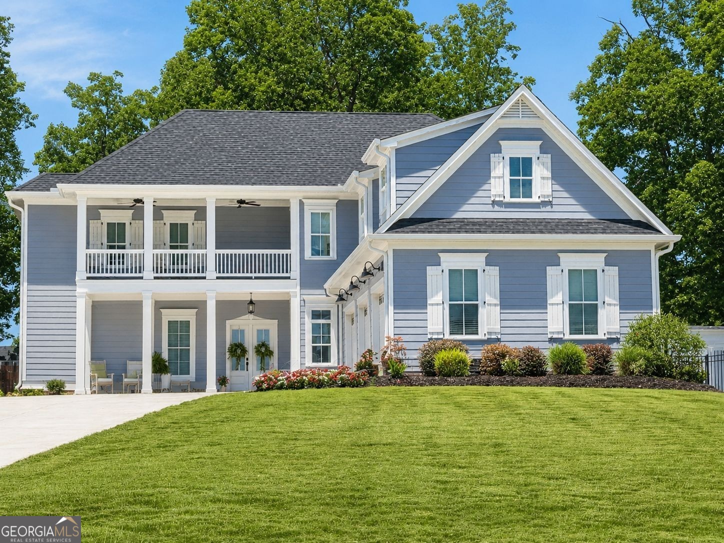 a front view of a house with a garden