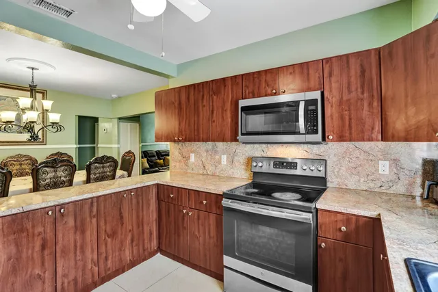 a kitchen with stainless steel appliances a stove microwave and sink