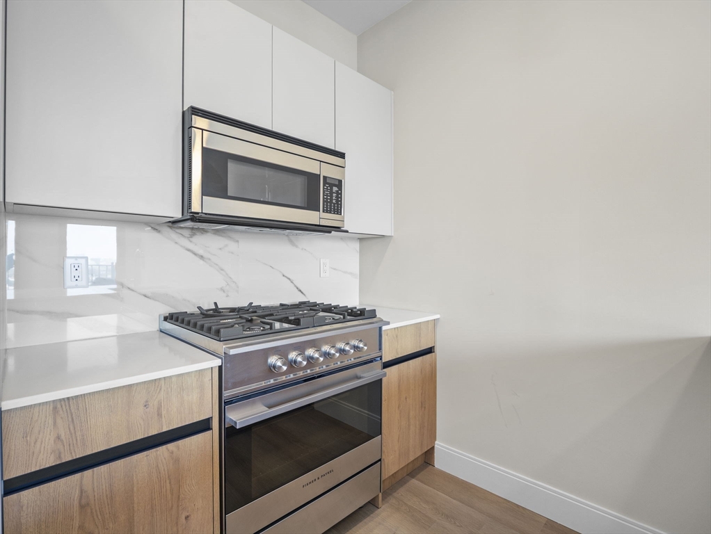 249 Corey Road, Unit 404 Boston, MA 02135 - Photo 6 of 30 a stove top oven sitting inside of a kitchen