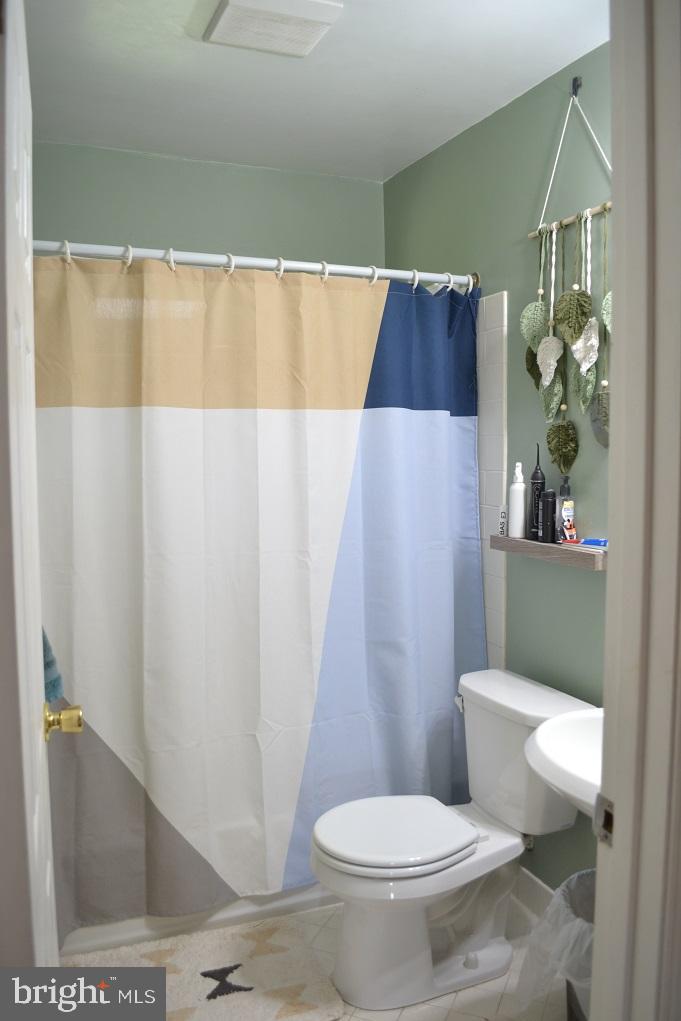 1837 Watson Road Abington, PA 19001 - Photo 26 of 33 a white toilet sitting next to a shower curtain