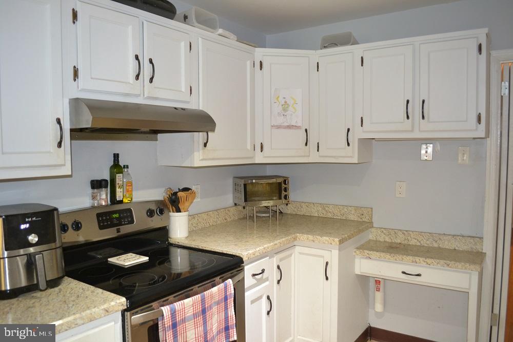 1837 Watson Road Abington, PA 19001 - Photo 10 of 33 a kitchen with granite countertop a stove and a white cabinets