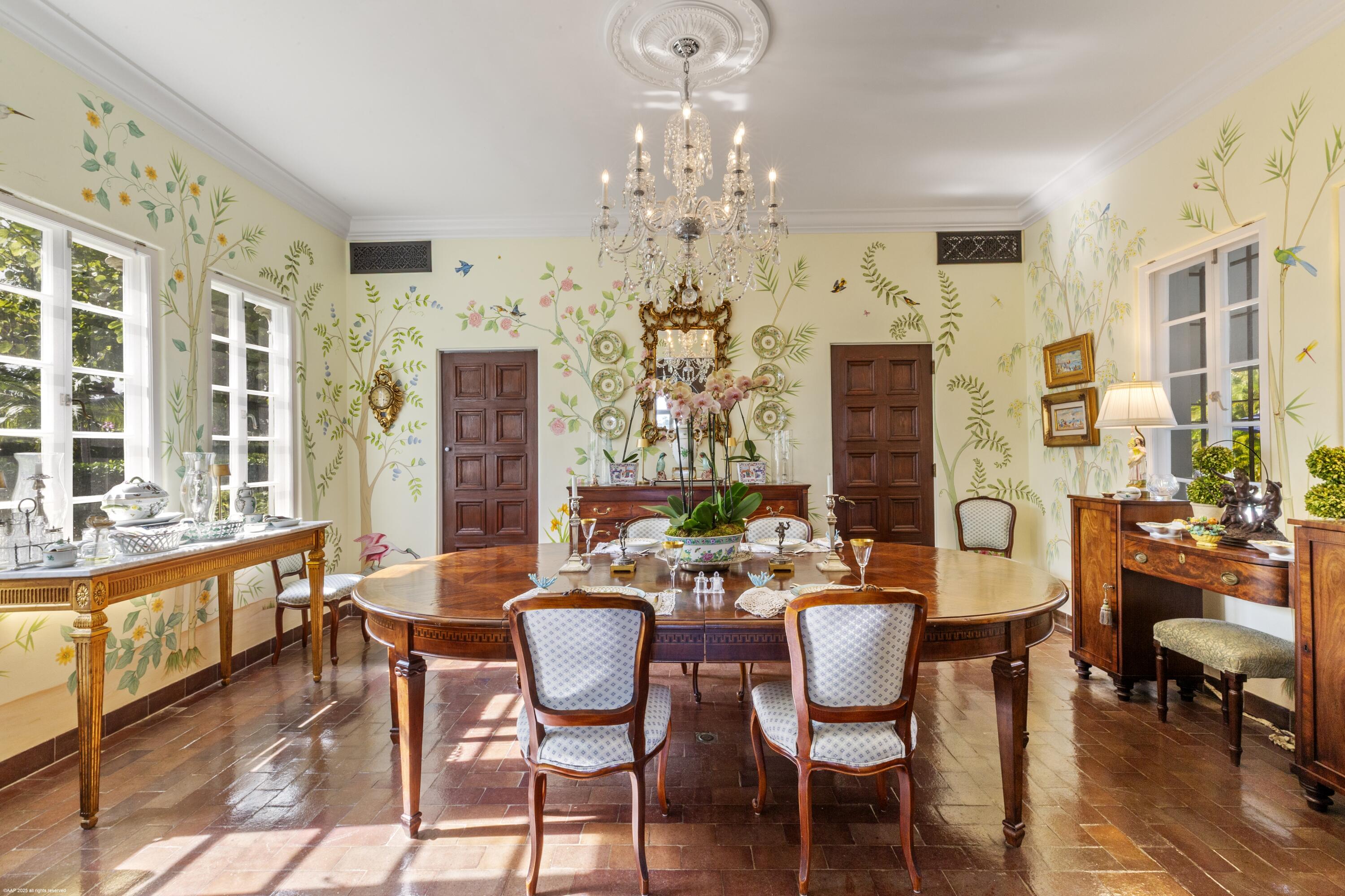 245 Valencia Road West Palm Beach, FL 33401 - Photo 16 of 39 a view of a dining room with furniture a chandelier and wooden floor