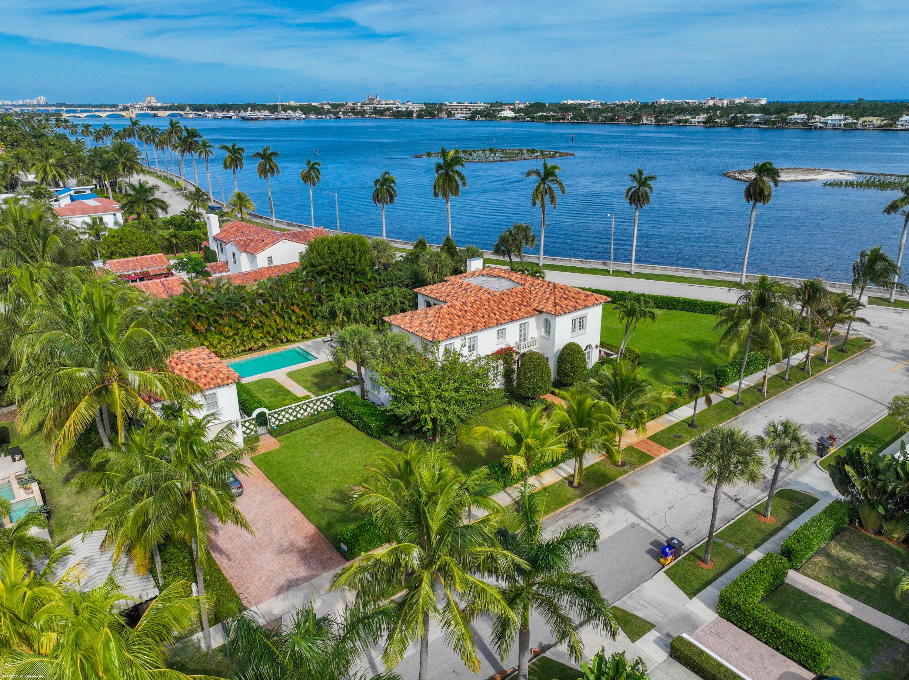 245 Valencia Road West Palm Beach, FL 33401 - Photo 2 of 39 an aerial view of a house with a garden and lake view