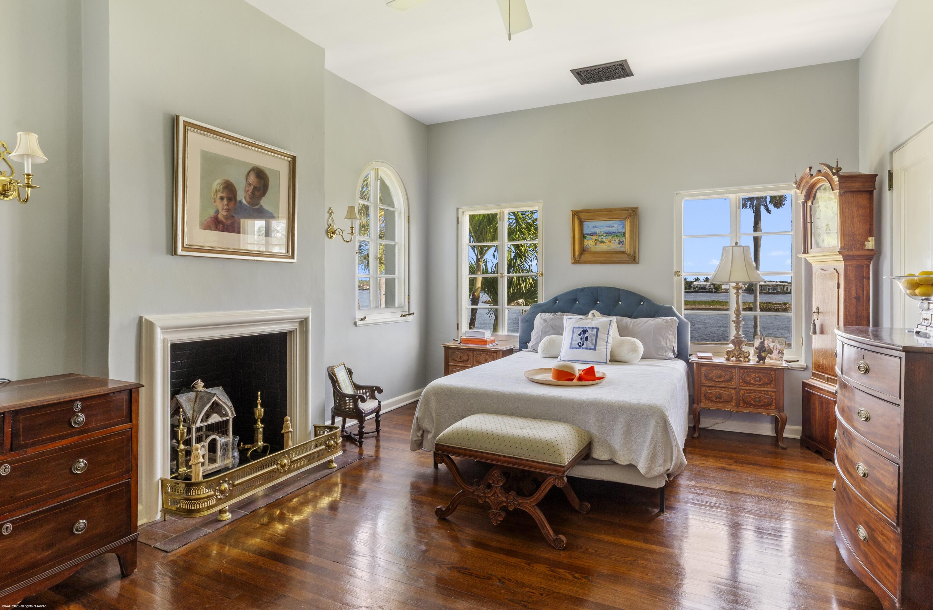 245 Valencia Road West Palm Beach, FL 33401 - Photo 21 of 39 a bedroom with a bed and a fireplace