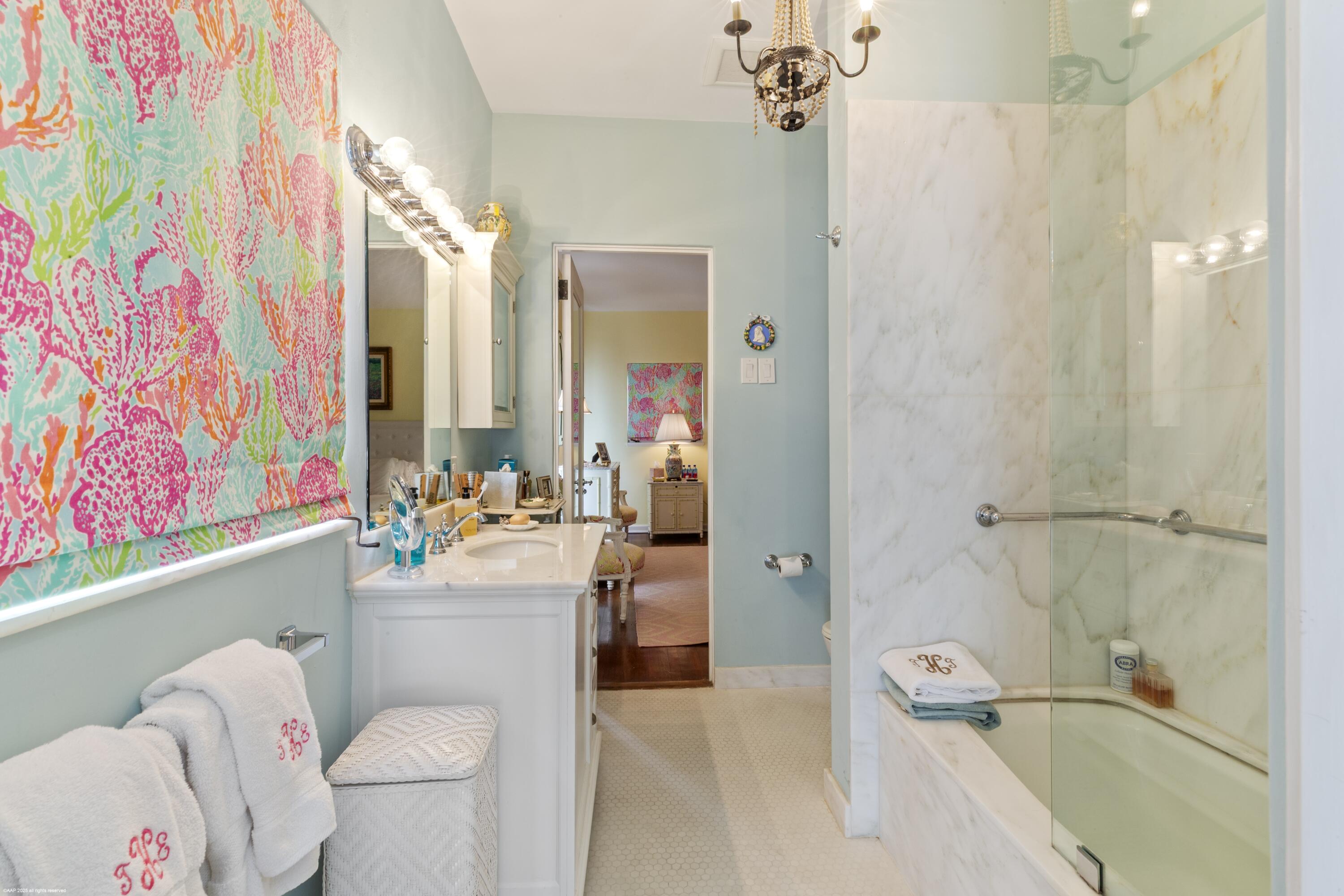 245 Valencia Road West Palm Beach, FL 33401 - Photo 24 of 39 a bathroom with a sink a toilet and shower curtain