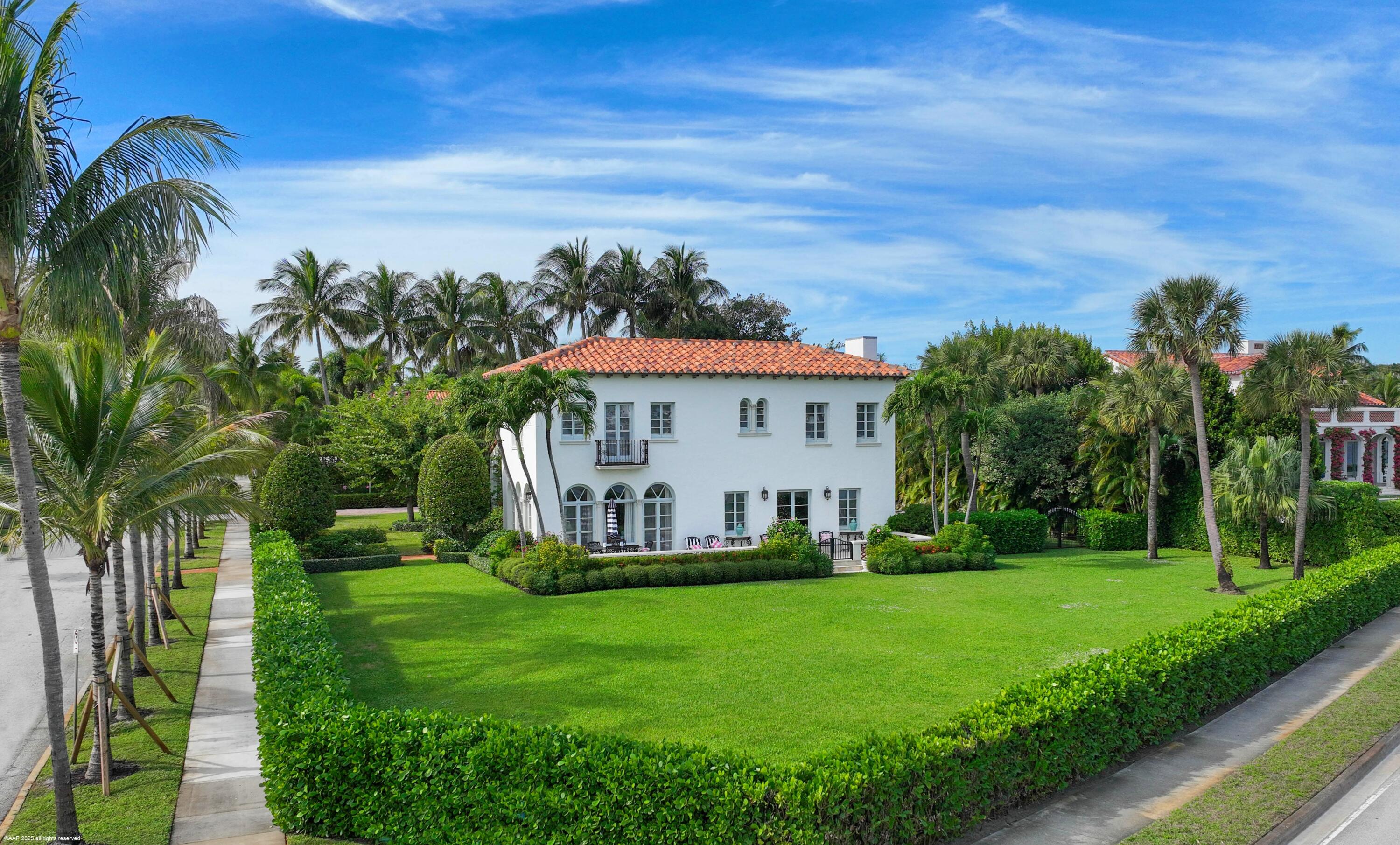 245 Valencia Road West Palm Beach, FL 33401 - Photo 3 of 39 a front view of a house with garden