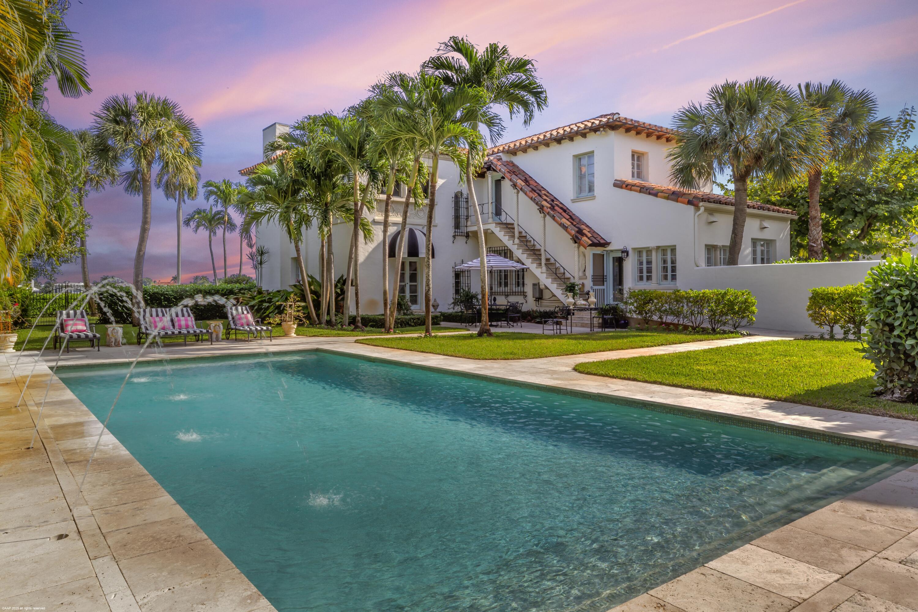 245 Valencia Road West Palm Beach, FL 33401 - Photo 33 of 39 a view of swimming pool with outdoor seating and house in the background