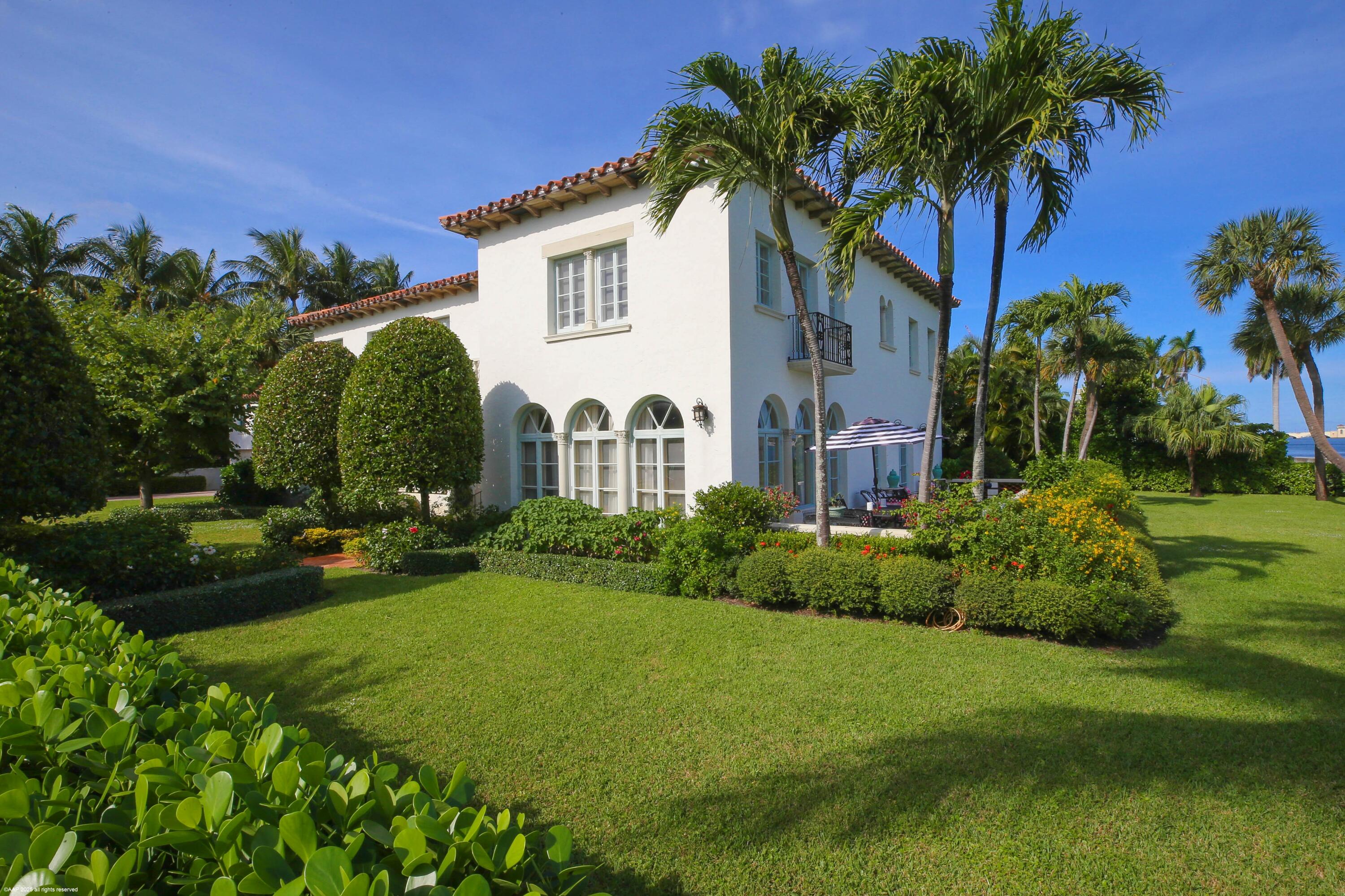 245 Valencia Road West Palm Beach, FL 33401 - Photo 4 of 39 a front view of a house with garden