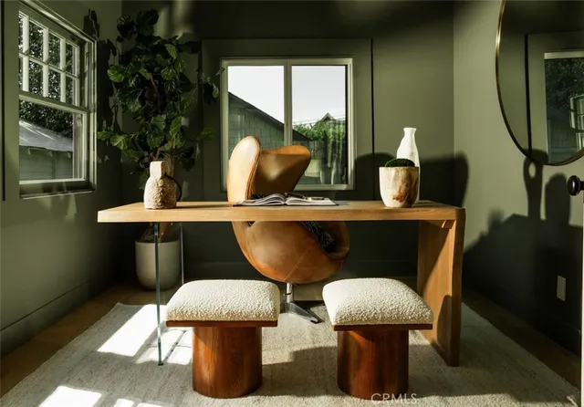 a living room with furniture a lamp and a potted plant