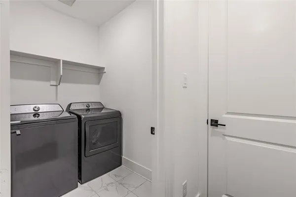 a view of a room with wooden floor and chandelier