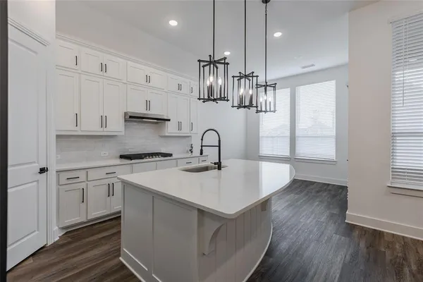 a kitchen with stainless steel appliances a sink stove and refrigerator
