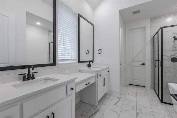 a bathroom with a double vanity sink a toilet and mirror