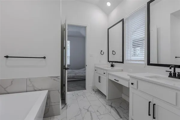 a front view of a house with a garden and yard