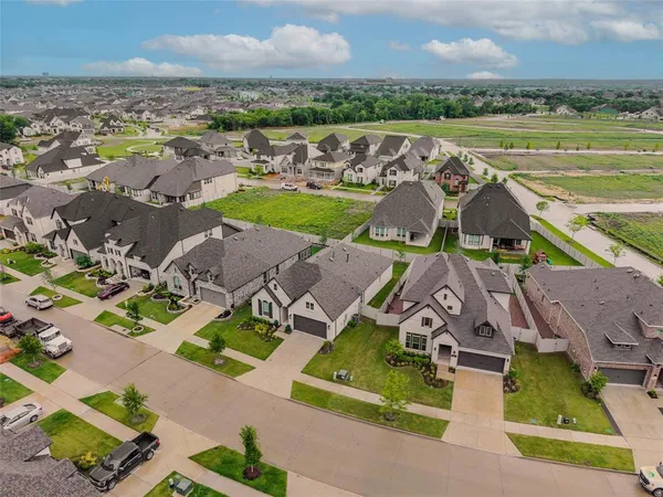 an aerial view of multiple houses with a yard