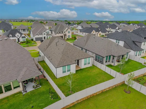 an aerial view of multiple houses with a yard