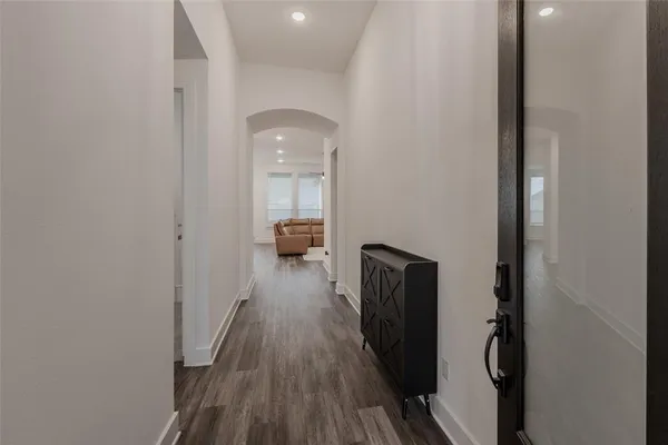 a view of hallway with wooden floor