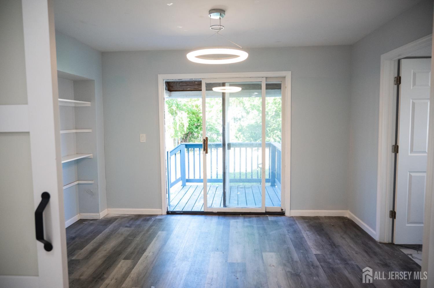 101 Perry Street Keyport, NJ 07735 - Photo 9 of 15 a view of an empty room with wooden floor and a window