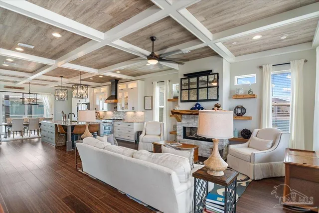 a kitchen with stainless steel appliances granite countertop a sink a stove and a wooden floors