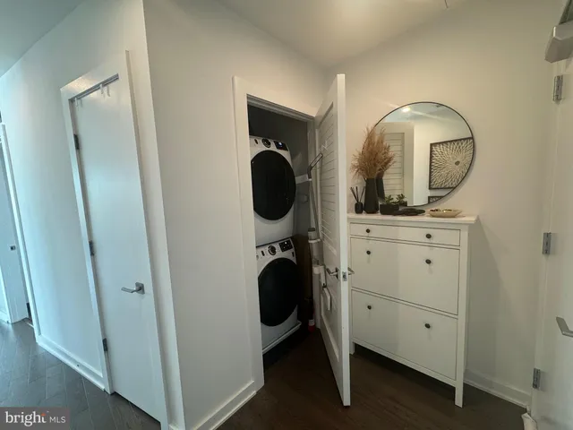 a view of a hallway with closet and mirror