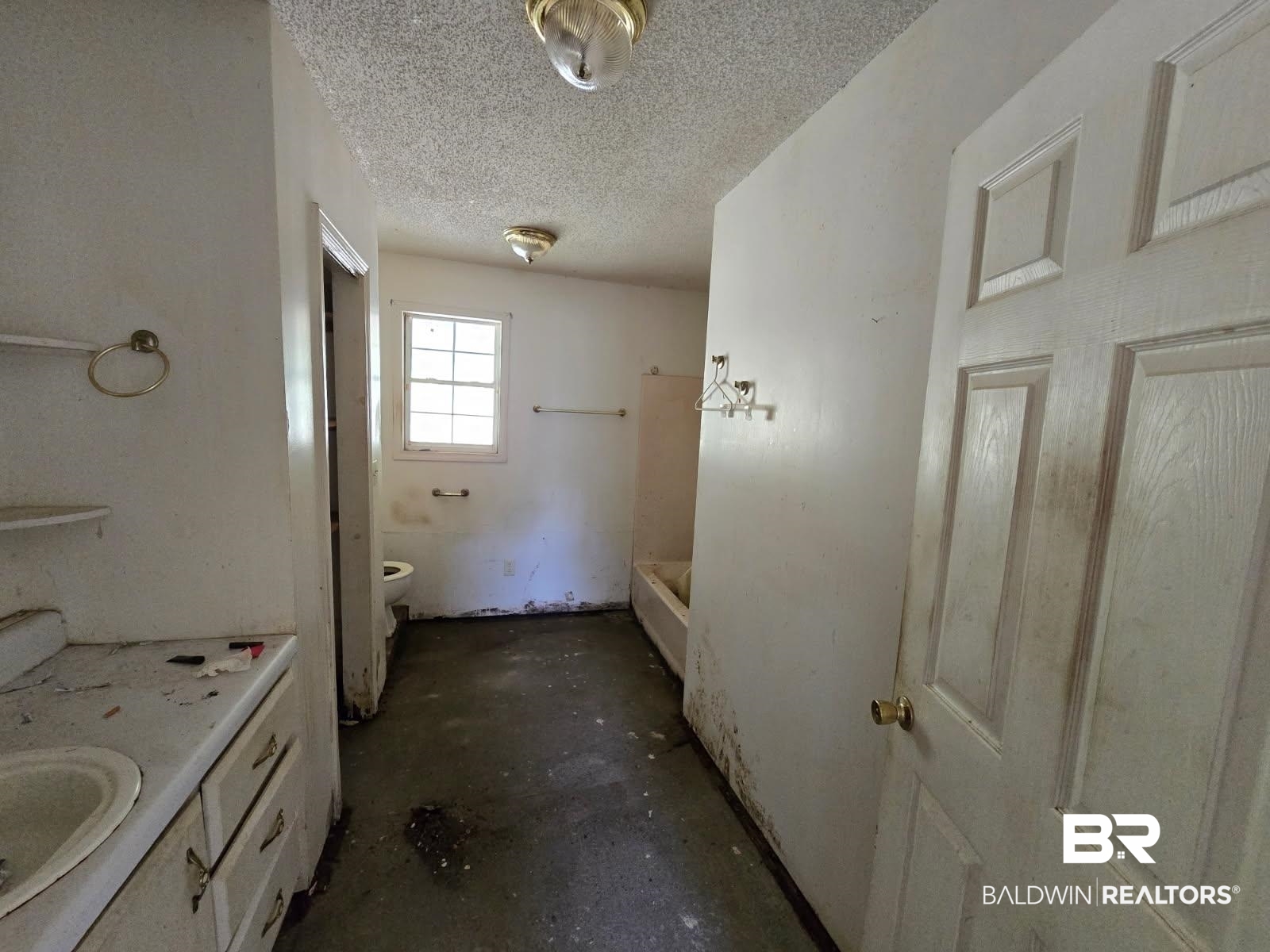 4072 Appleton Road Brewton, AL 36426 - Photo 5 of 7 Bathroom with a shower, unfinished concrete flooring, toilet, vanity, and a textured ceiling