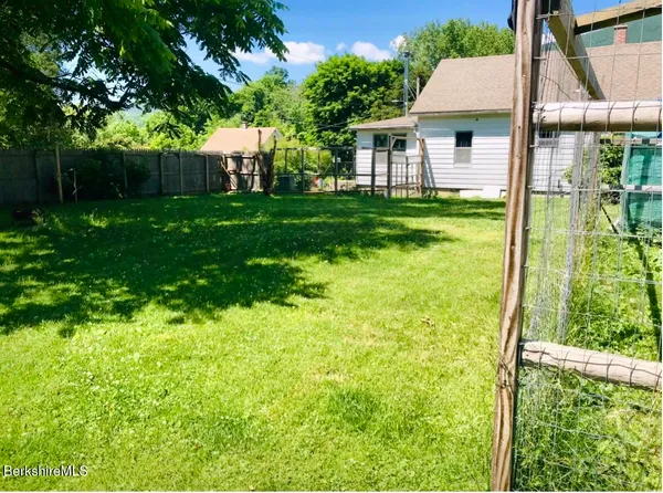 a view of a yard with a house in the background