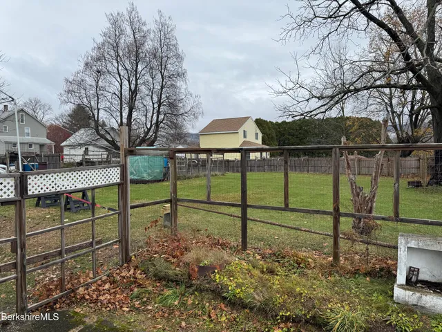 a view of a park with iron fence