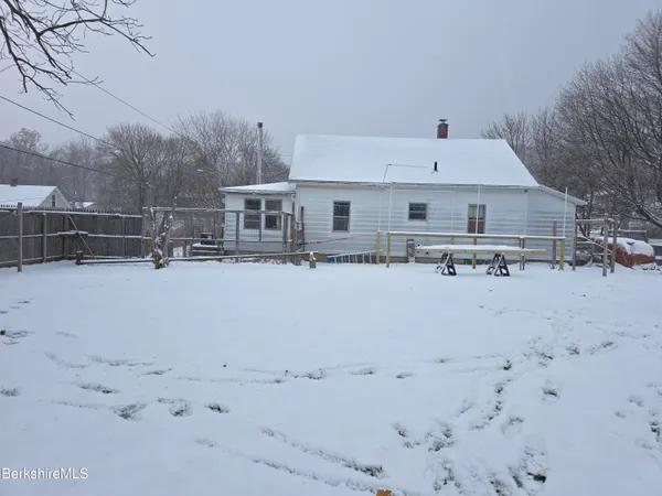 a view of house with snow in the background