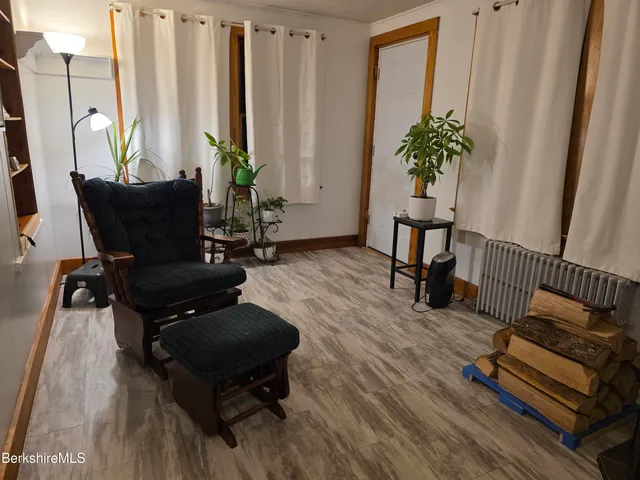 a living room with furniture rug and a window