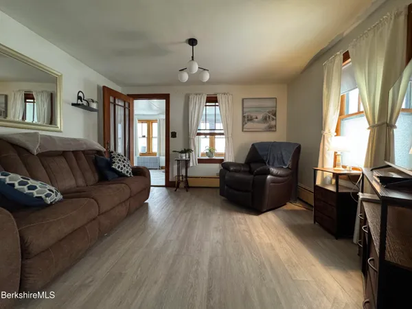 a living room with furniture fireplace and a large window