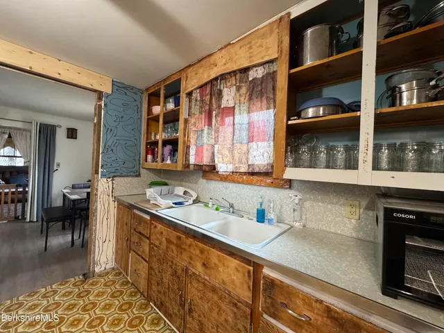 a kitchen with a sink and a stove top oven