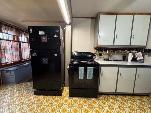 a kitchen with a refrigerator and a stove