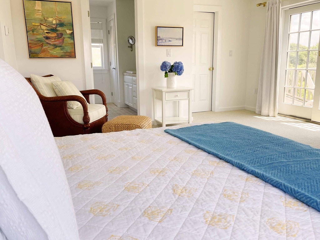 7 Packet Drive Nantucket, MA 02554 - Photo 27 of 38 a bedroom with a bed and a painting on the wall