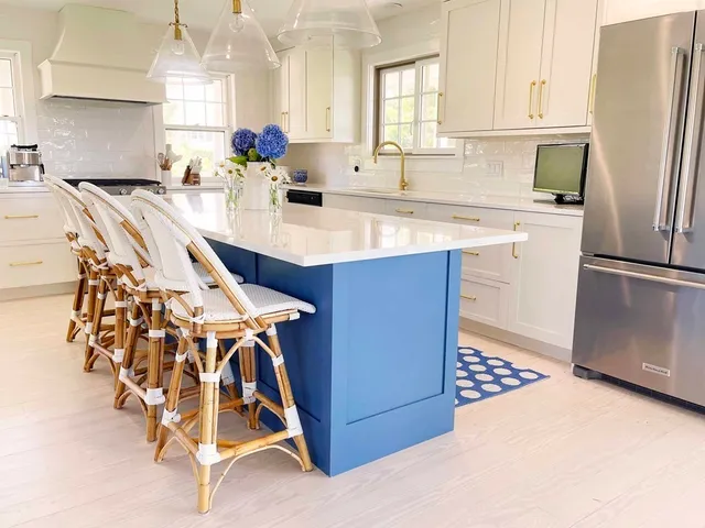 a kitchen with stainless steel appliances kitchen island granite countertop a sink a stove and refrigerator